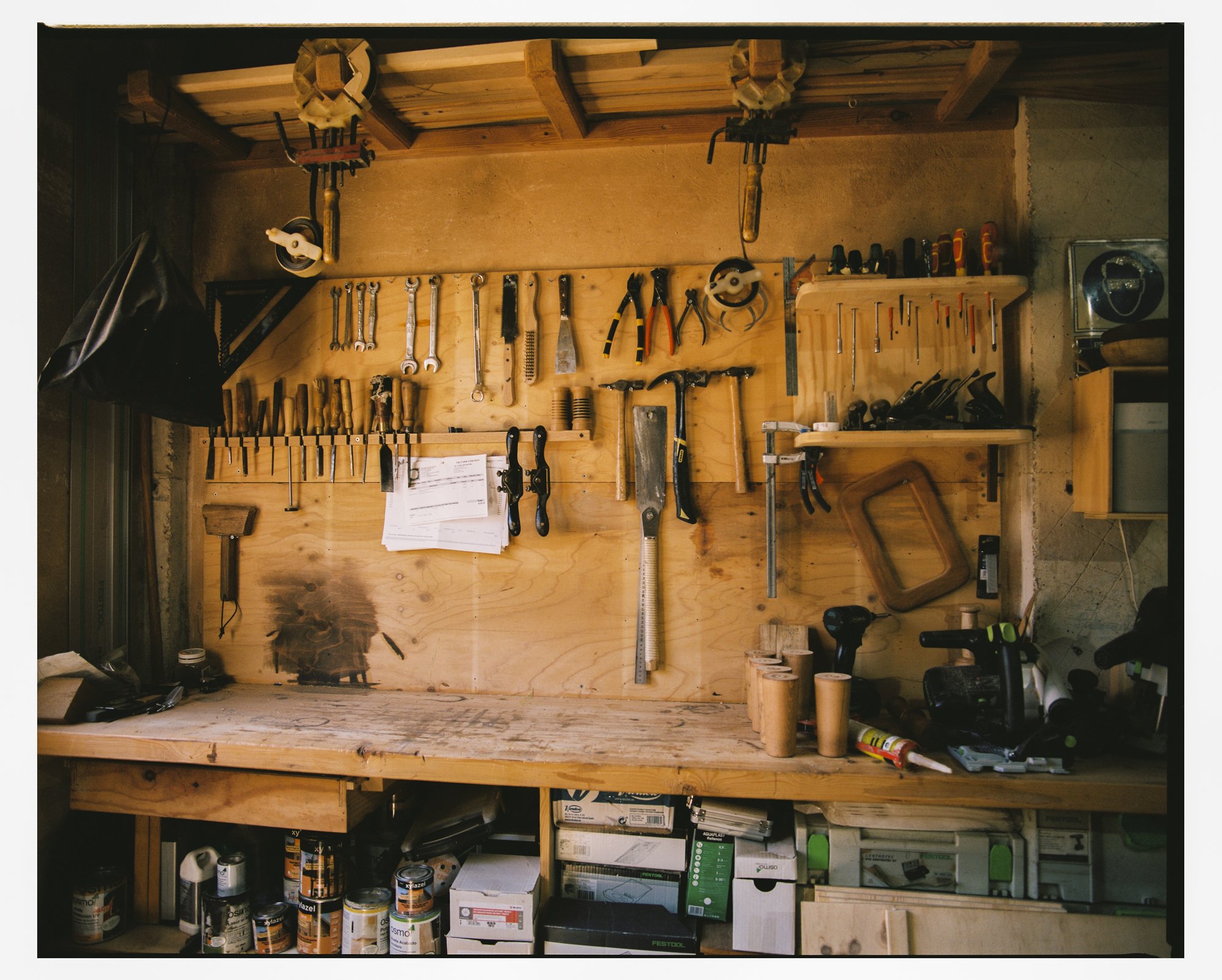 Inside the workshop, tools and timber within reach of the bench.